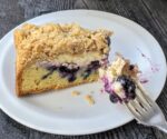 slice of blueberry cheese crumbcake on plate with fork