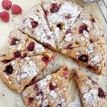 Raspberry Almond Scones on a sheet of parchment paper