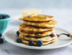 stack of blueberry buttermilk pancakes on plate with fork