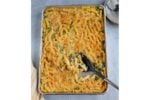 sheet pan mac and cheese with serving spoon