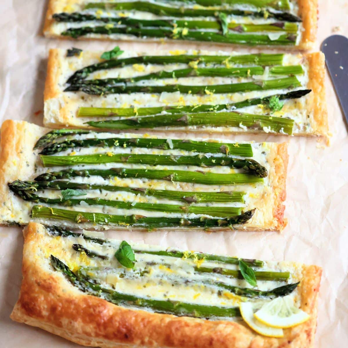 asparagus tart cut into pieces on a board.