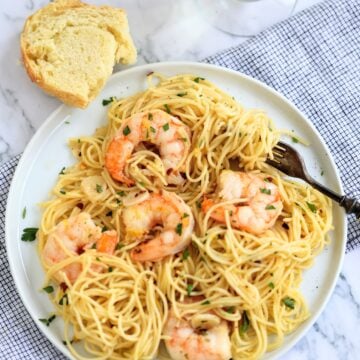 bowl of garlicky shrimp scampi pasta with fork