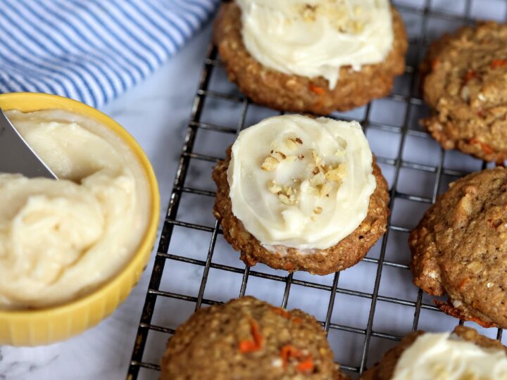 Carrot Cake Cookies on wore rack with bowl of cream cheese icing