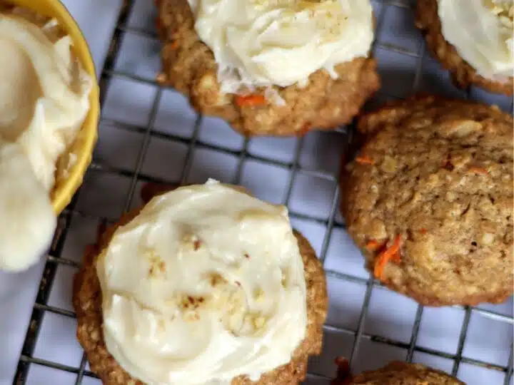 Carrot cake cookies with cream cheese icing on wire rack.