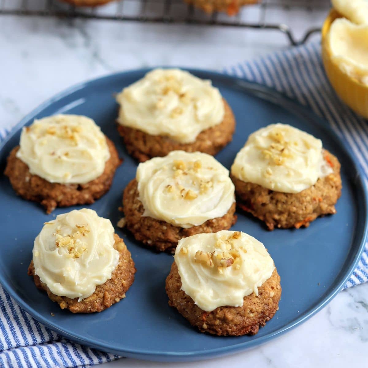 Plate of carrot cake cookies with cream cheese frosting.