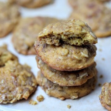 Stack of four pumpkin nut oatmeal cookies with top one broken in half