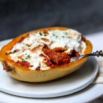 Bolognese-Stuffed Spaghetti Squash on a plate with a forkful removed