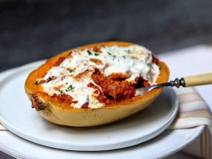 Bolognese-Stuffed Spaghetti Squash on a plate with a forkful removed