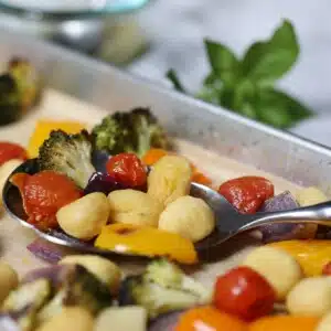 Sheet pan gnocchi with vegetables and pesto.