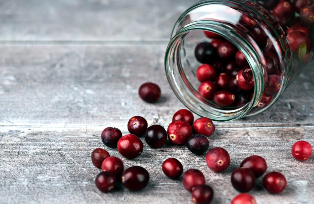 Fresh cranberries spilling from a jar