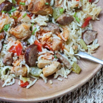 Close up on bowl with Spicy Sausage and Chicken Jambalaya with fork.