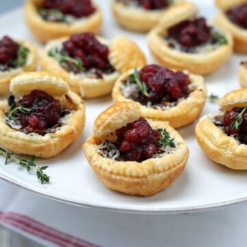 close of mini mushroom tart on serving patter.