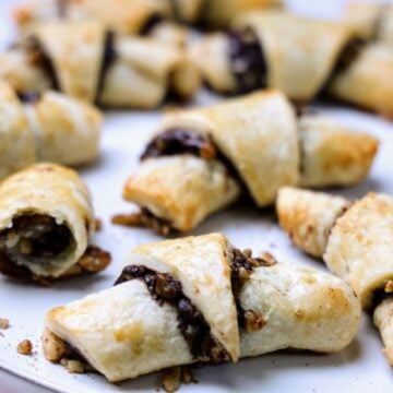 close up of chocolate-walnut rugelach on a serving platter