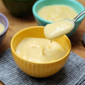 spoonful of lemon pudding over bowl.