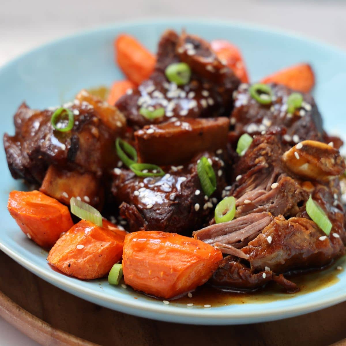 instant pot asian short ribs on plate with carrots. 