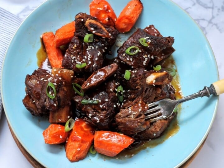 Instant pot Asian short ribs on plate with carrots.