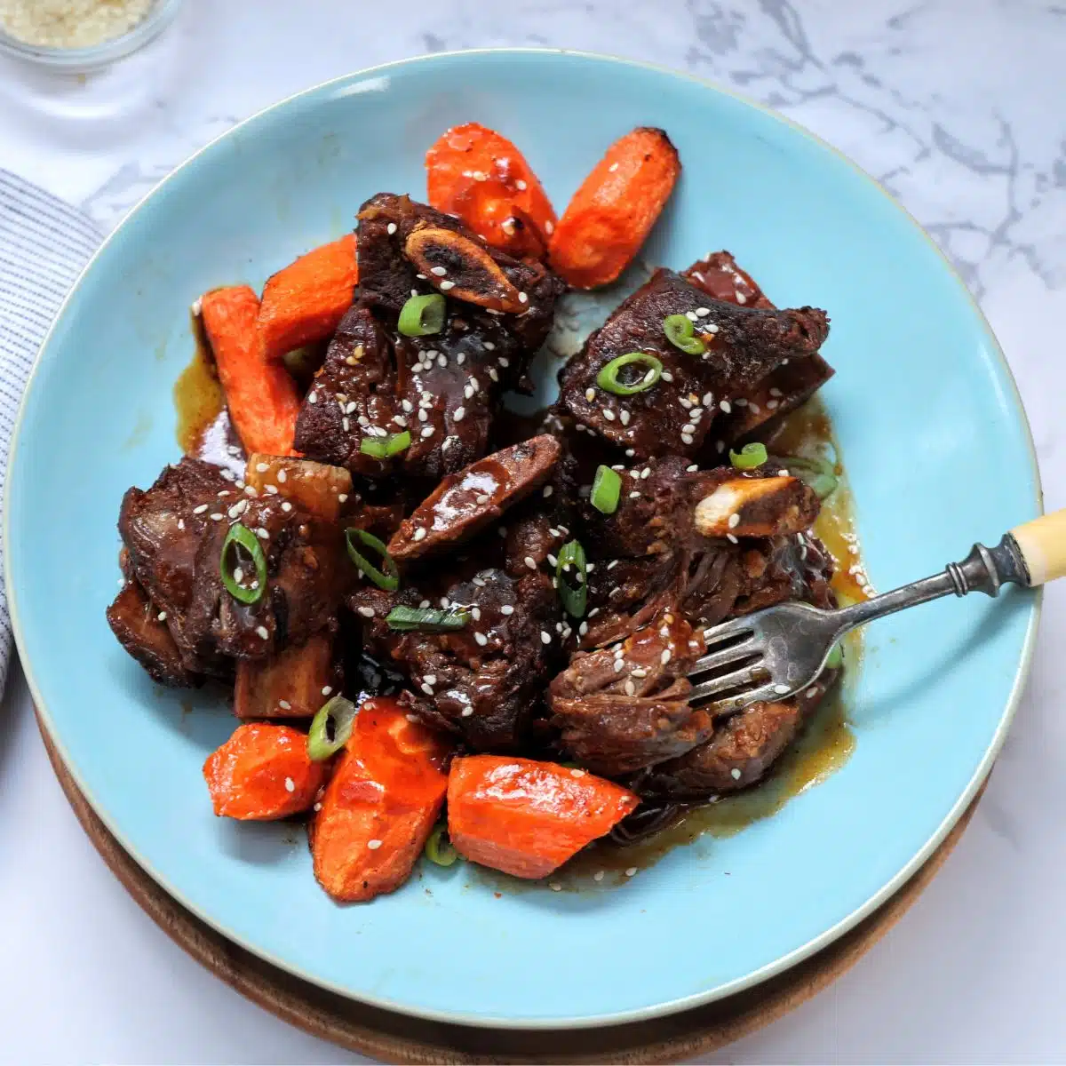 Instant pot Asian short ribs on plate with carrots.