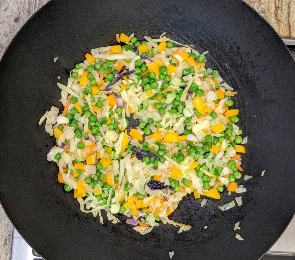 cooked stir fry veggies in a wok