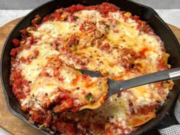 Cast iron skillet with vegetable lasagna.