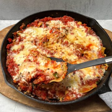 Cast iron skillet with vegetable lasagna.