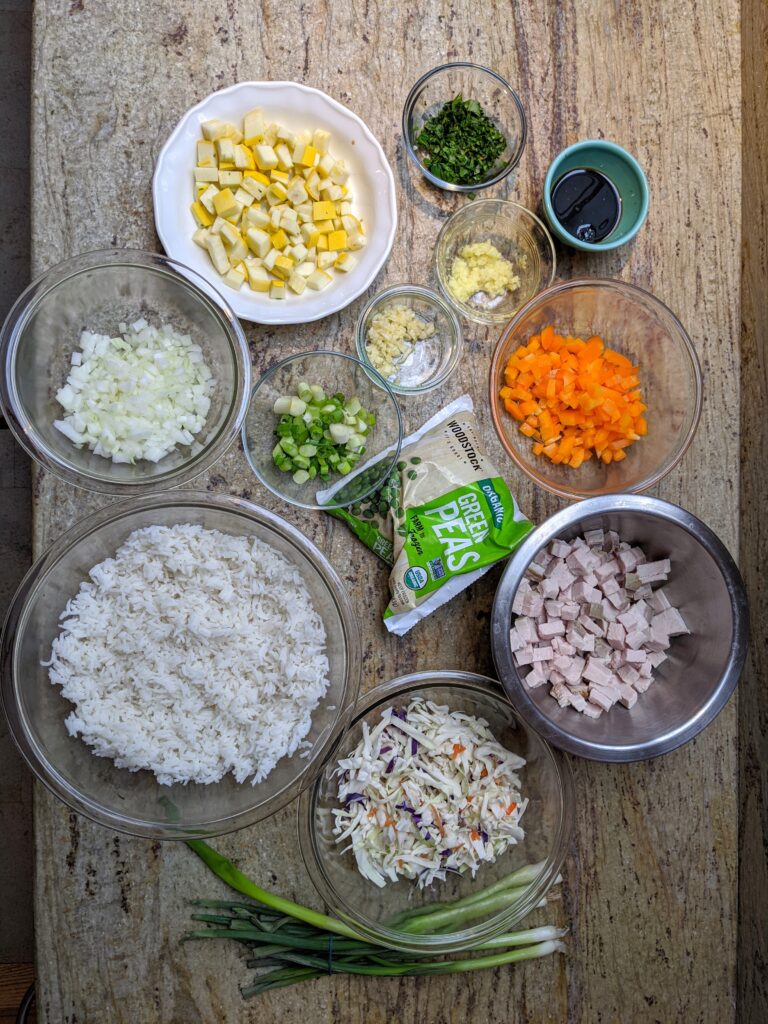 ingredients shot of rice, chicken, cabbage, bell pepper, ginger, peas, scallions oil, eggs, garlic, salt, white pepper, soy sauce, gochujang sauce