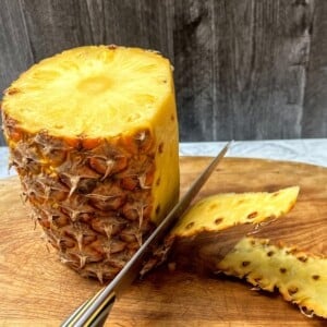 Step 2 for cutting pineapple. Cut off the peel.