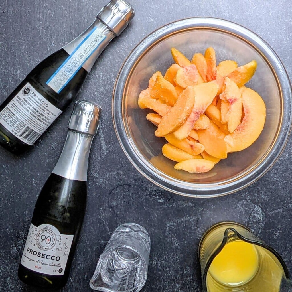 ingredients to make frozen peach bellinis.