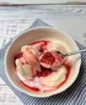 Bowl of vanilla ice cream with easy strawberry compote.