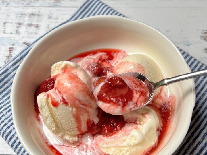 Bowl of vanilla ice cream with easy strawberry compote.