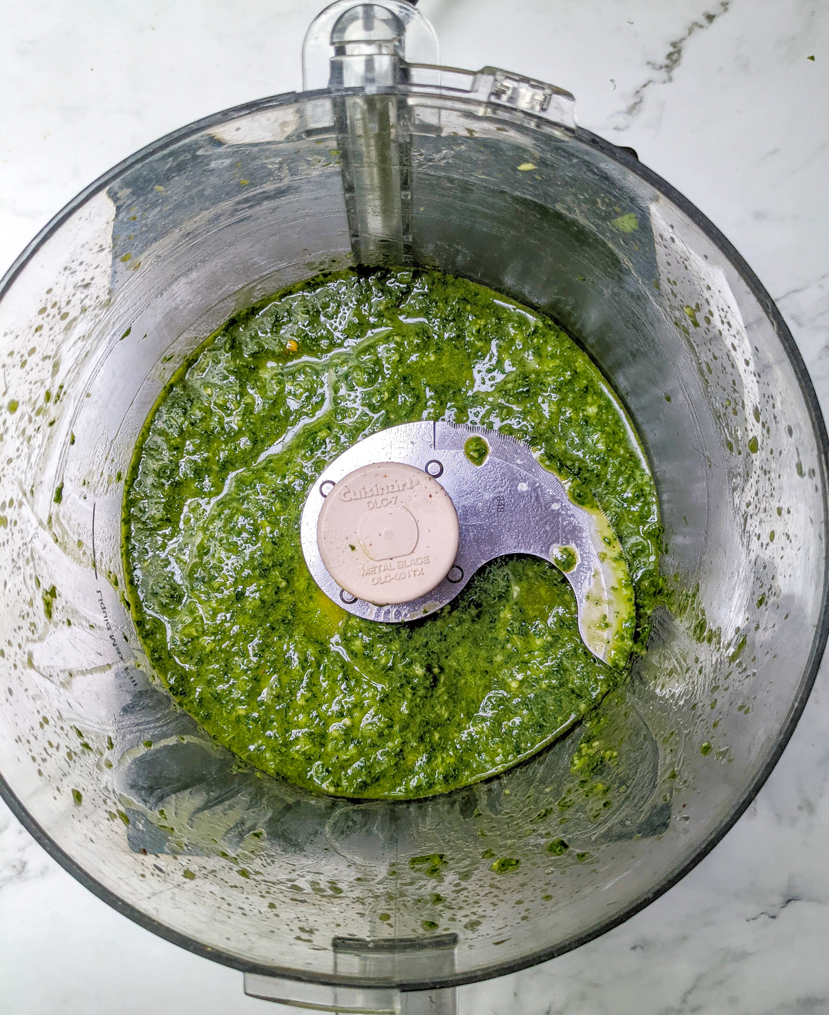 Overheaed view of chimichurri sauce in food processor.