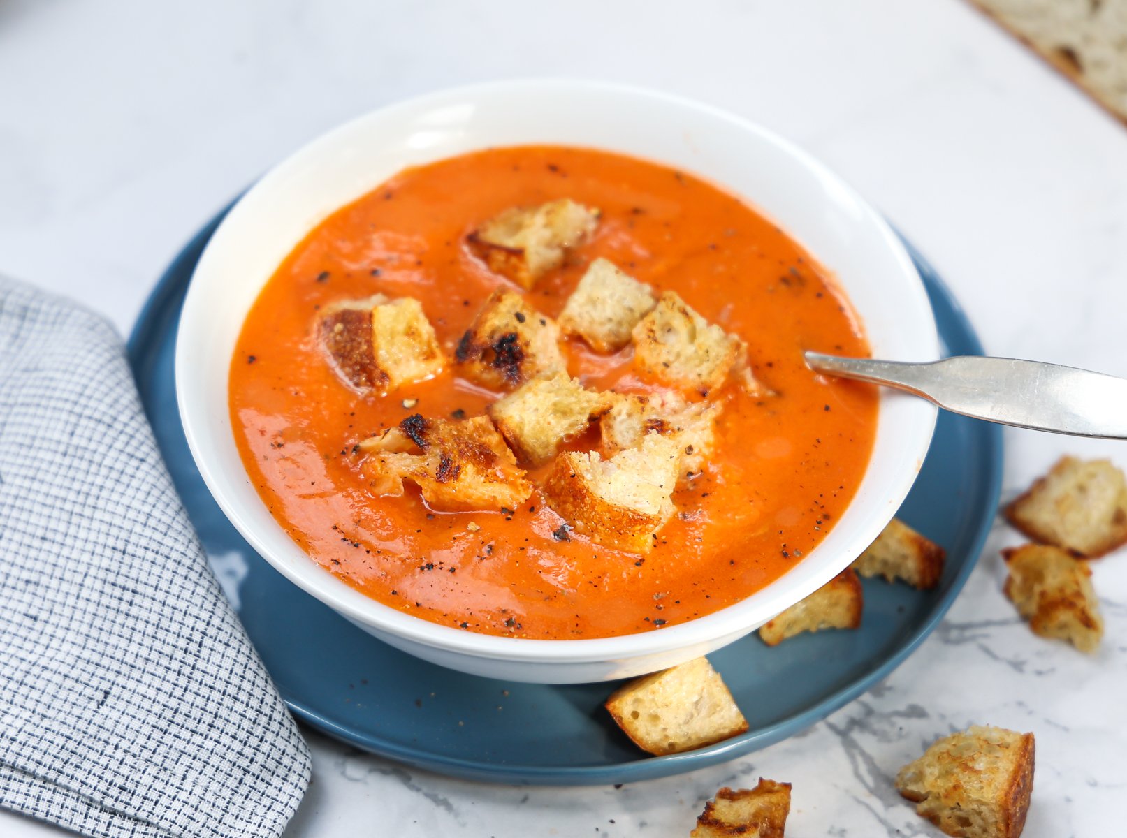 Bowl of tomato soup with croutons. 