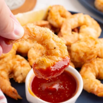 Fried shrimp dipped in cocktail sauce.