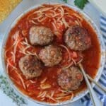 Overhead shot of bowl with albondigas and a spoon.