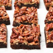 Pecan pie brownies cut into squares on marble.