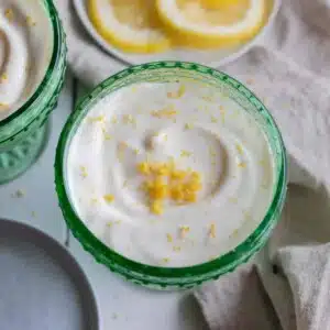 Whipped cottage cheese lemon mousse in a green glass bowl.