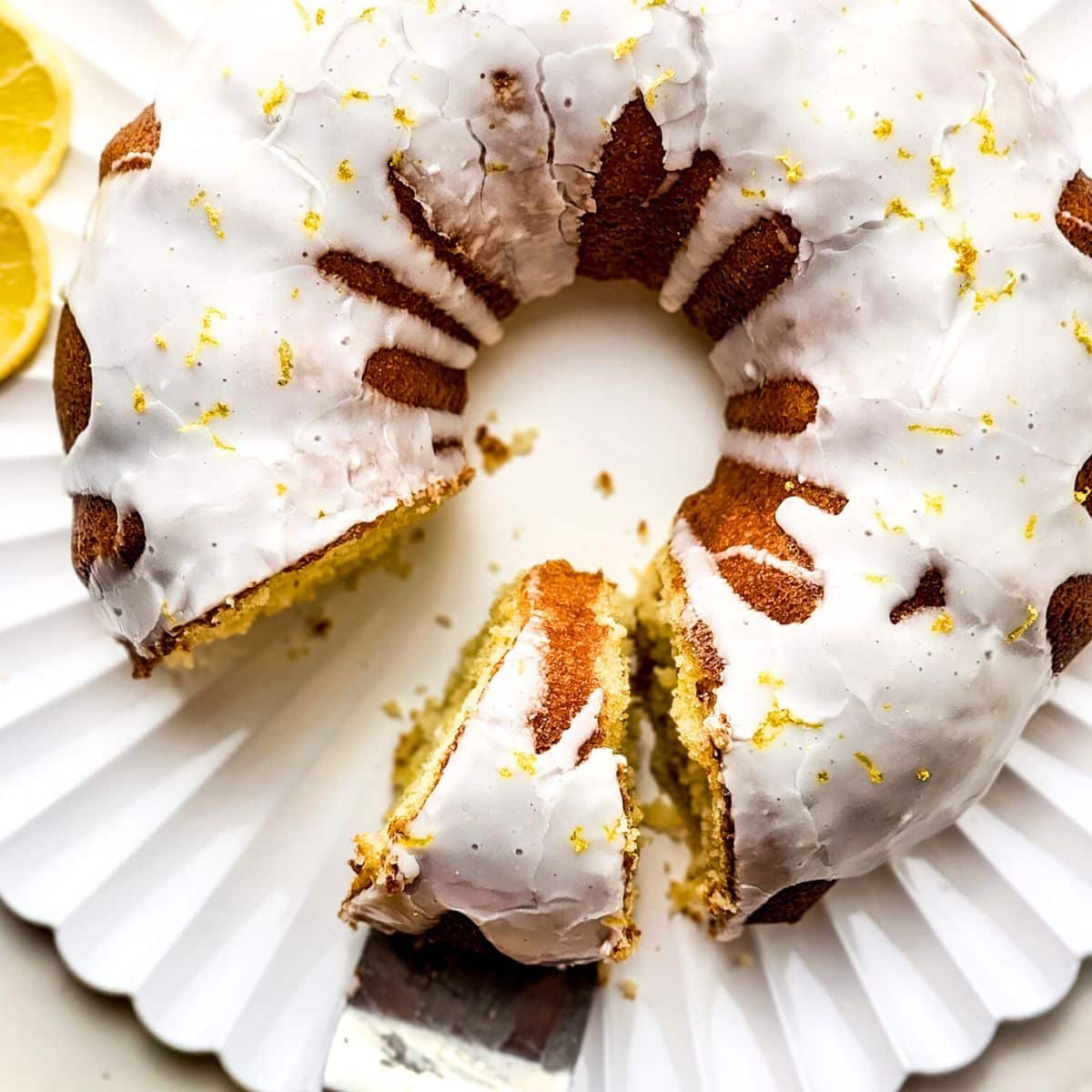Lemon bundt cake on a white serving platter.
