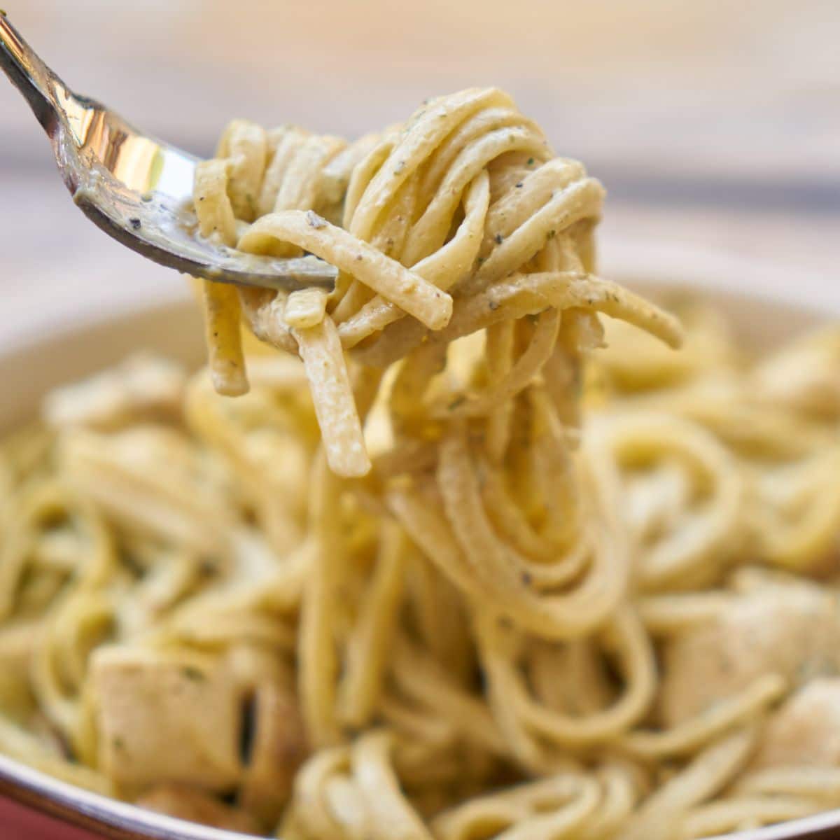 Pasta being twirled on a fork.