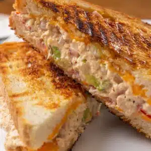 Tuna melt sandwich cut in half and stacked.