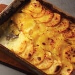 Scalloped potatoes iin a casserole dish.