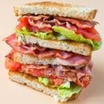 BLT Sandwich haves staked on a plate.