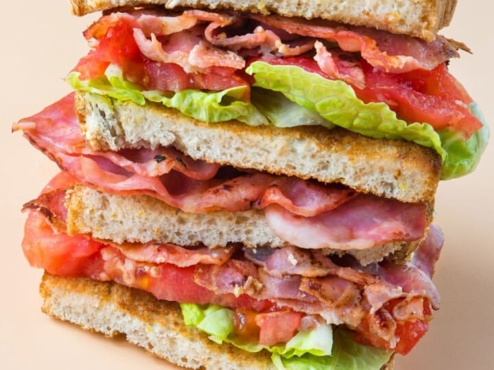 BLT Sandwich haves staked on a plate.
