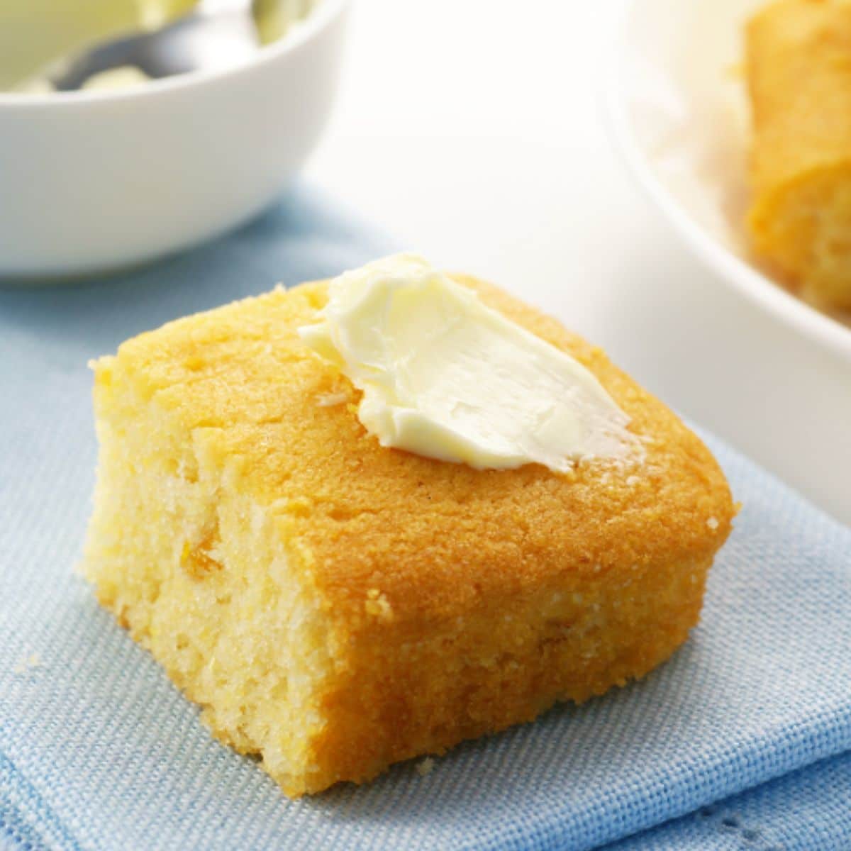 Slice of cornbread with butter. 