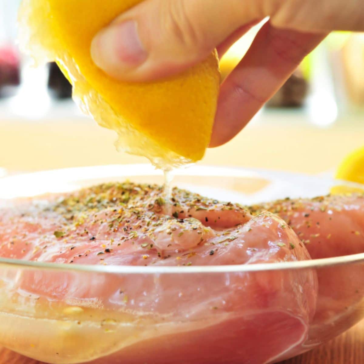 Marinating chicken in a glass dish.