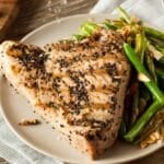 Grilled fish steak on plate.